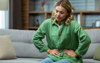 a women holding his stomach and feel stressed