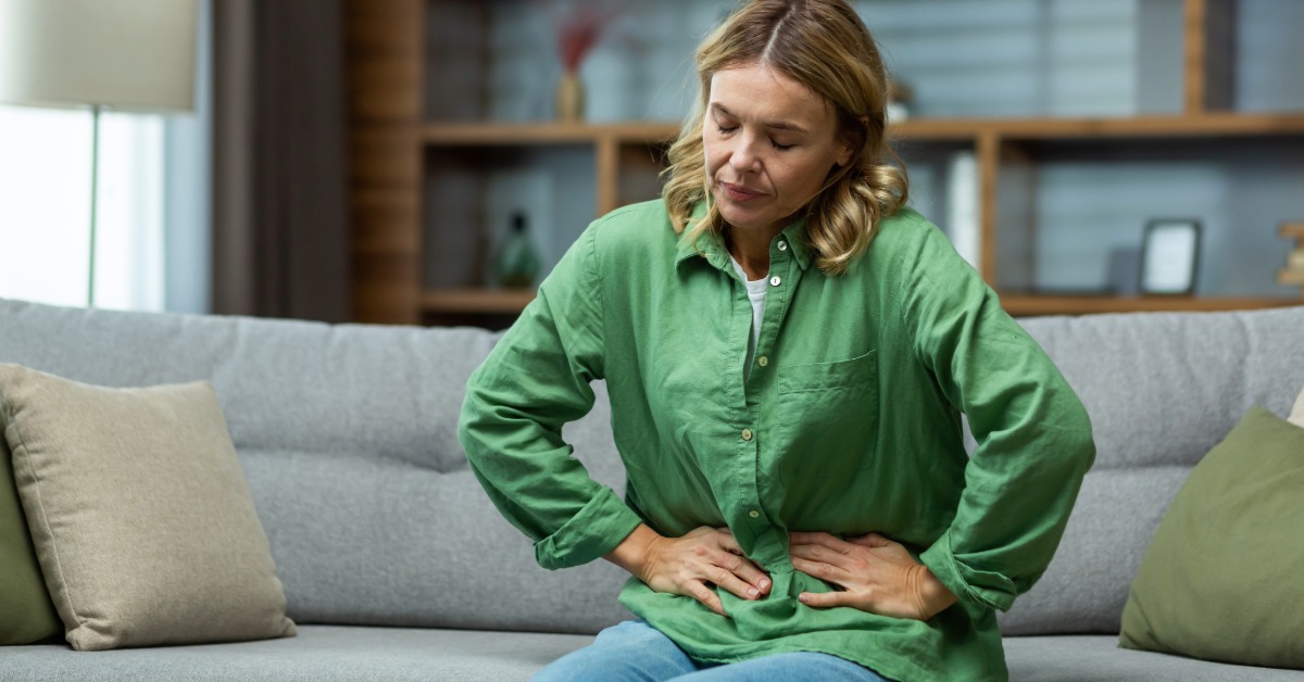 a women holding his stomach and feel stressed