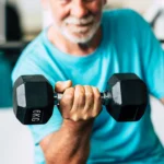 Couple of two happy and fitess seniors doing exercise in the gym together running on the tapis roulant